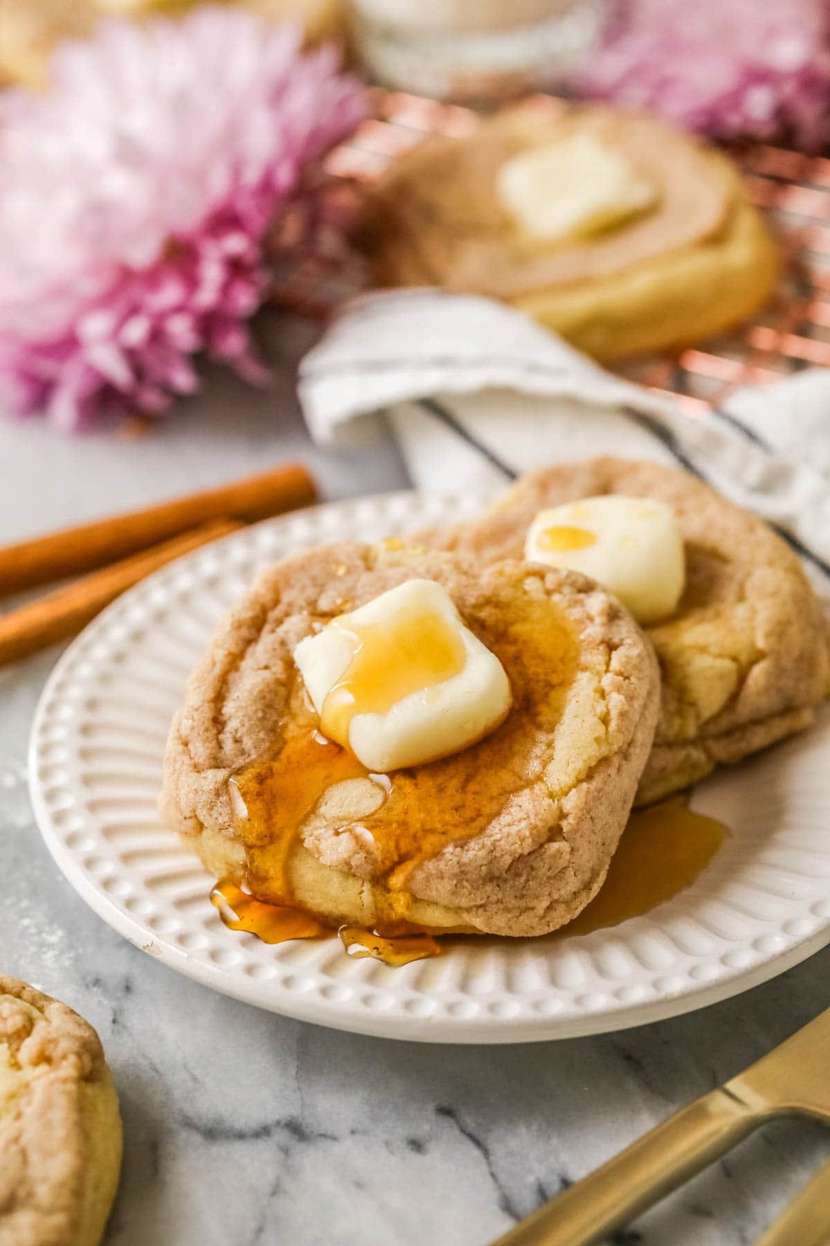 French toast cookies topped with buttercream butter pats and maple syrup.