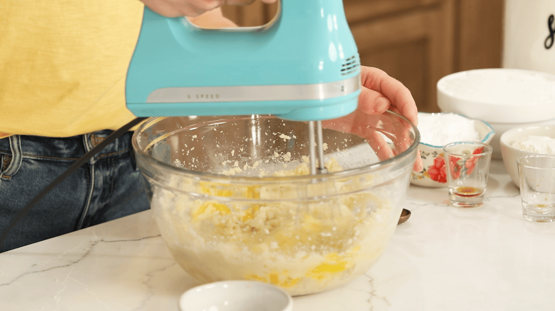 Adding eggs to the cookie dough