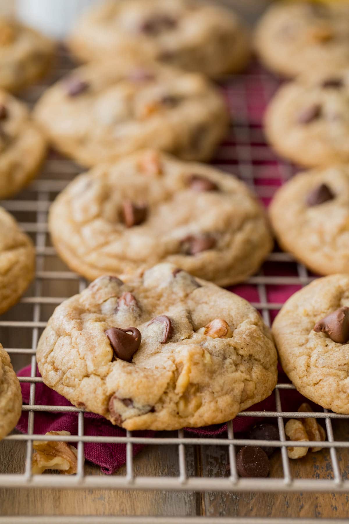 Rows of cookies made with bananas, chocolate chips, and pecans on a cooling rack.