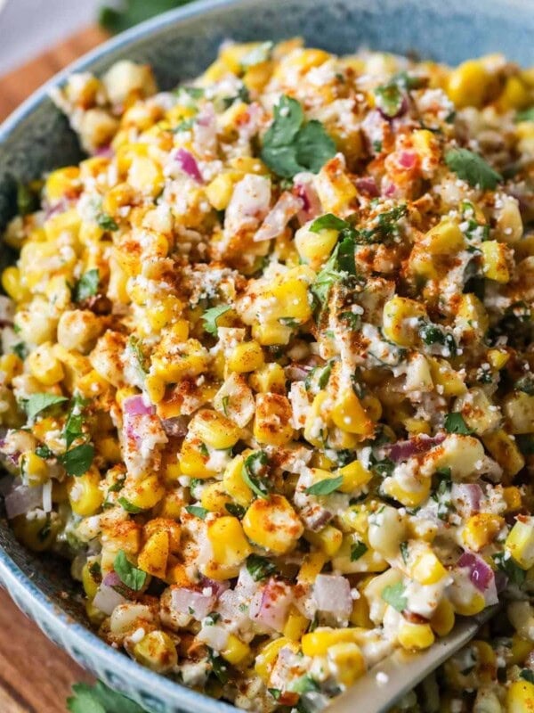 Overhead view of a bowl of Mexican street corn salad in a blue serving bowl.