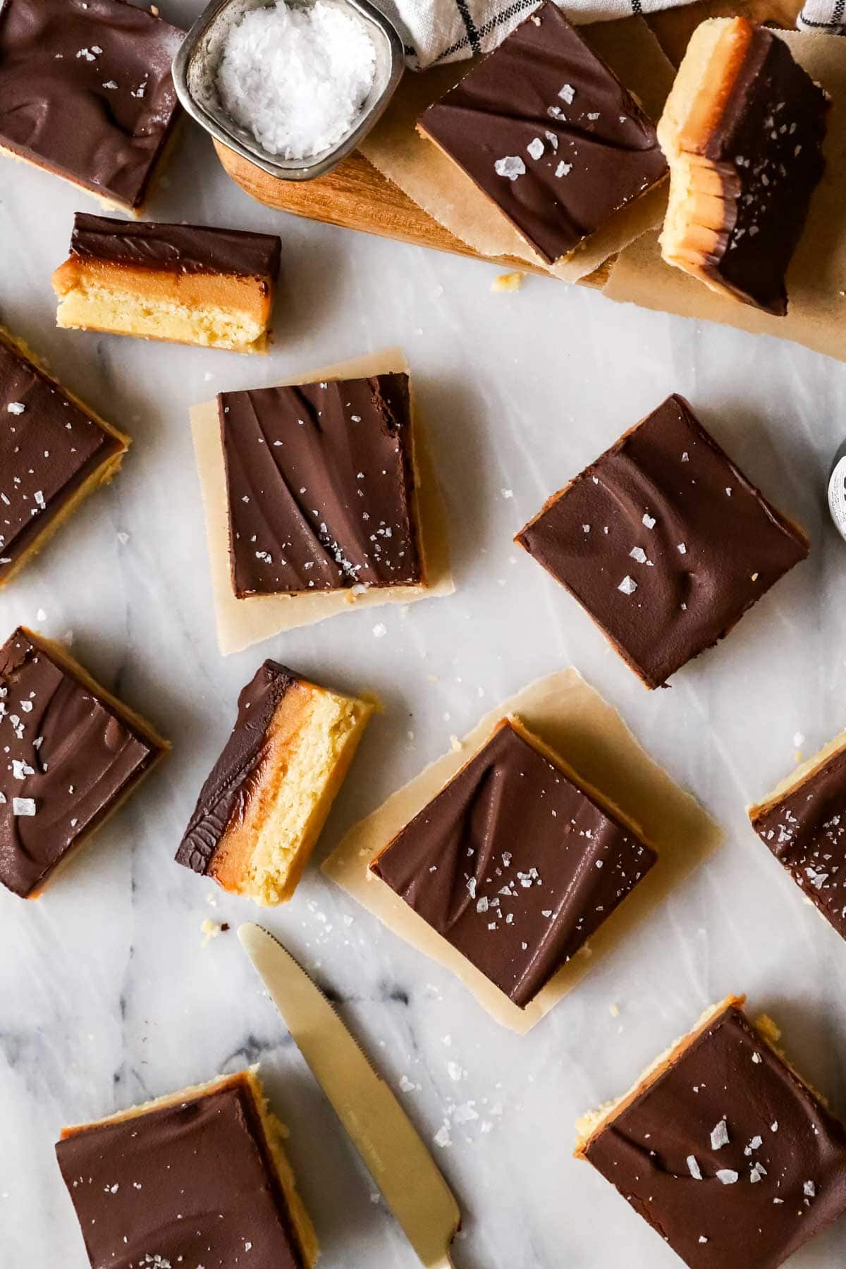 An overhead of millionaire's shortbread slices, showing salted ganache surfaces as well as the three distinct layers.
