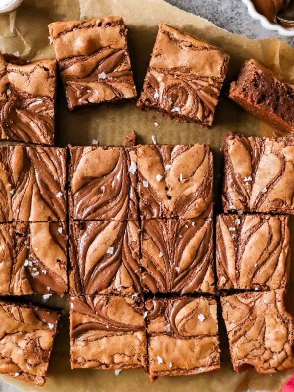 Overhead view of squares of Nutella brownies with swirled tops and sea salt.