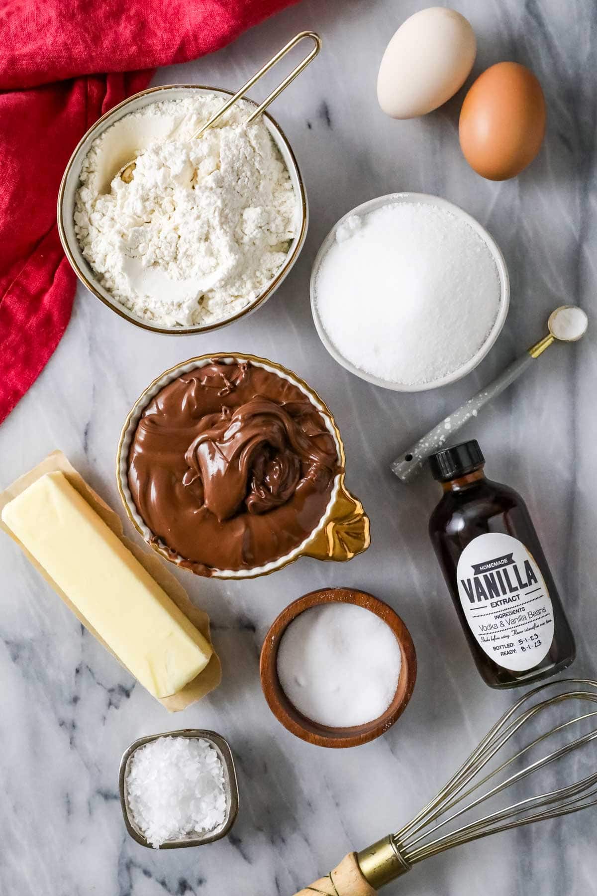 Overhead view of ingredients including Nutella, flour, eggs, and more.