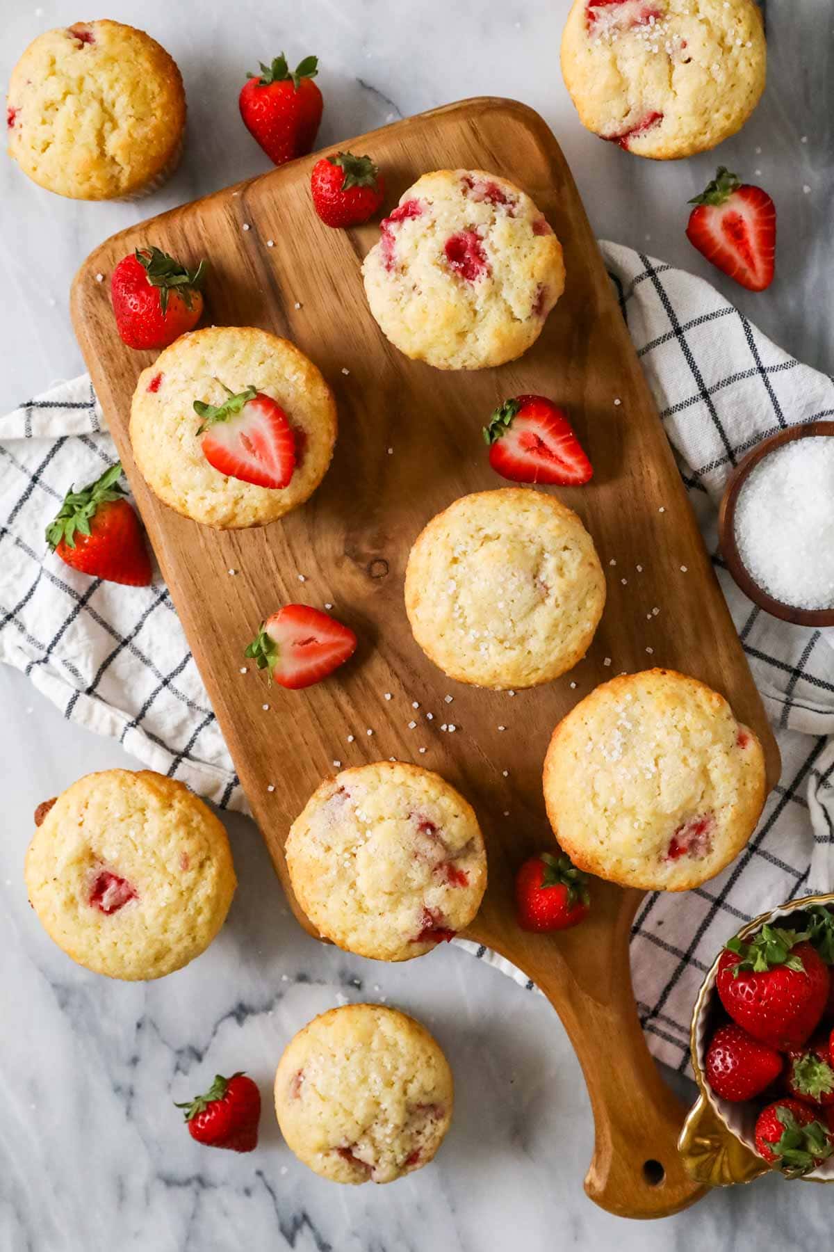Overhead view of muffins made with fresh strawberries on a serving board.