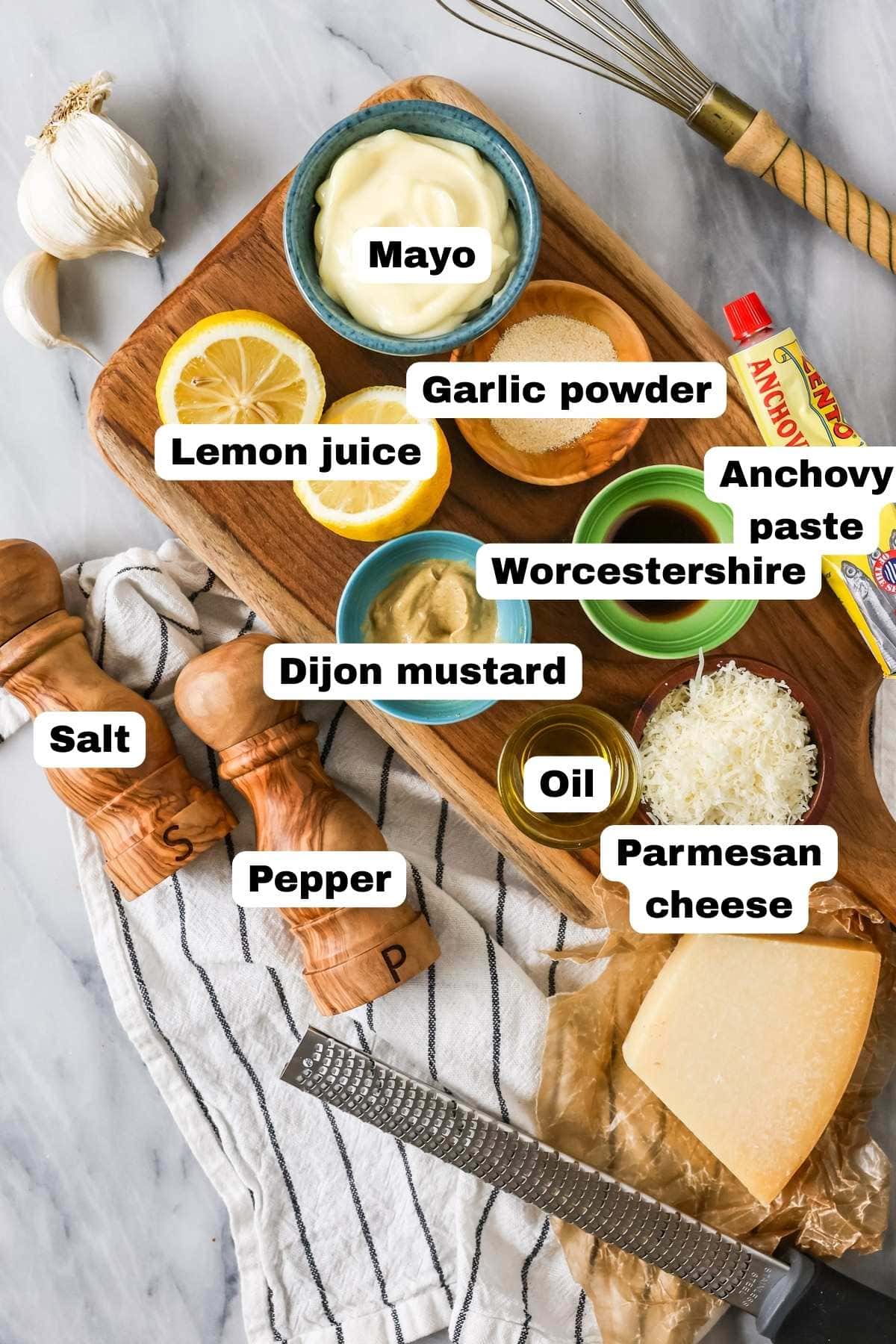 Overhead view of labeled ingredients including mayo, anchovy paste, worcestershire sauce, and more.