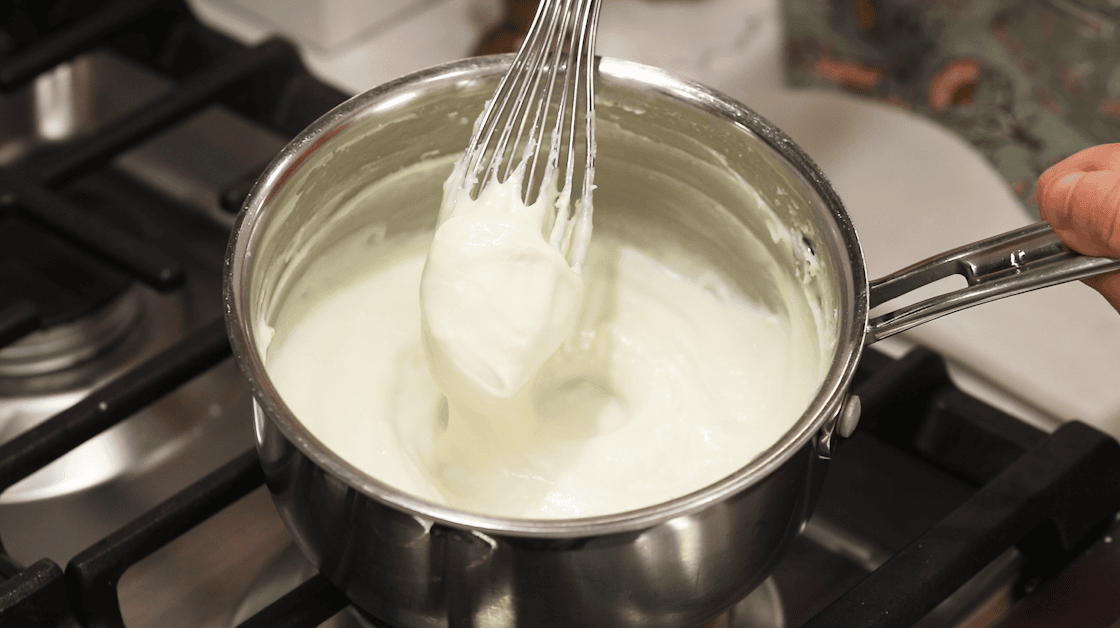 Thickened roux balling up on a whisk.