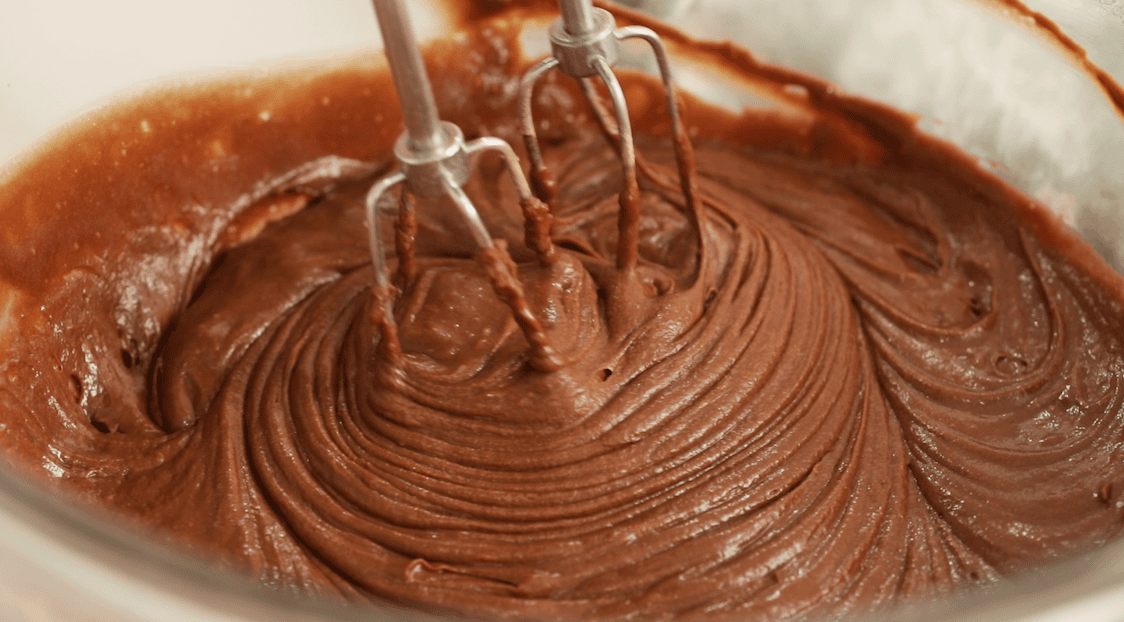 Beaters mixing a chocolate batter for whoopie pies.