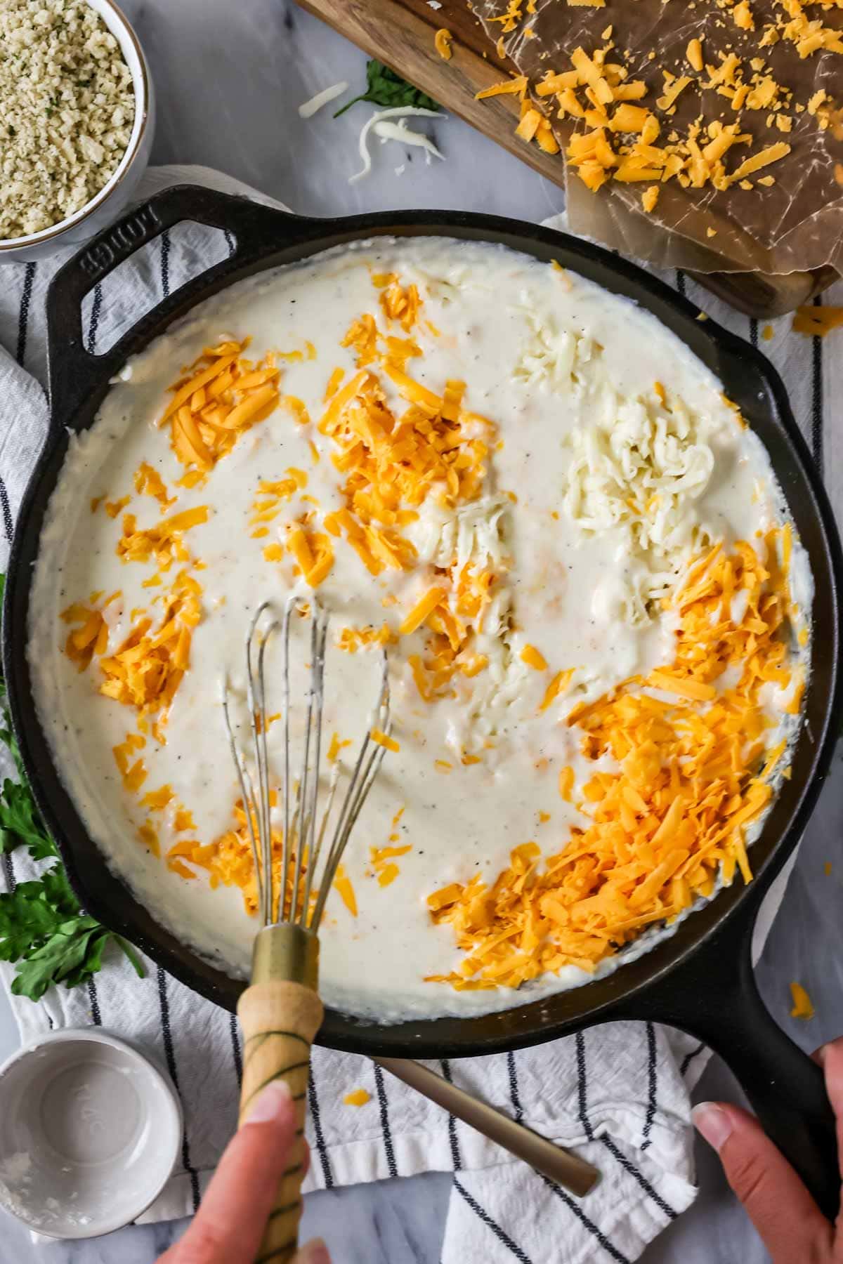Melting cheese into the mac and cheese sauce.