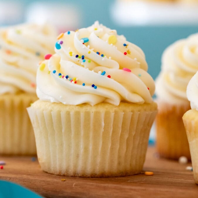 Head-on view of a cupcake frosted with buttercream frosting and sprinkles.