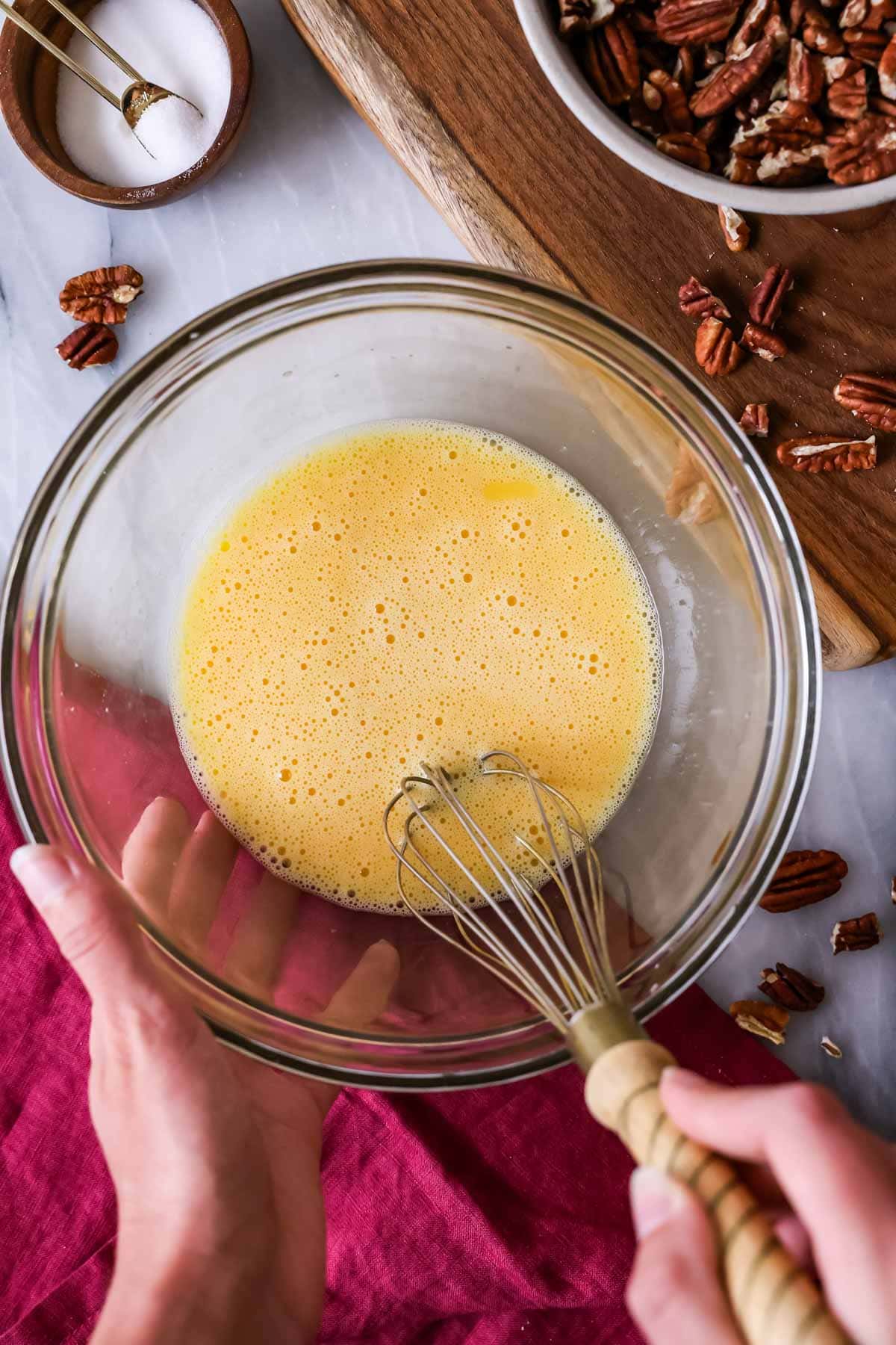 Overhead view of eggs being whisked until foamy.