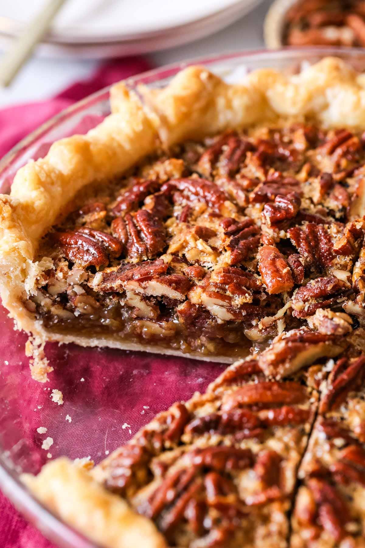 Cross section of a pecan pie showing a crisp crust and perfectly set filling.