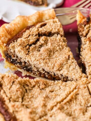 Shoofly pie that's been cut into slices in a pie plate.