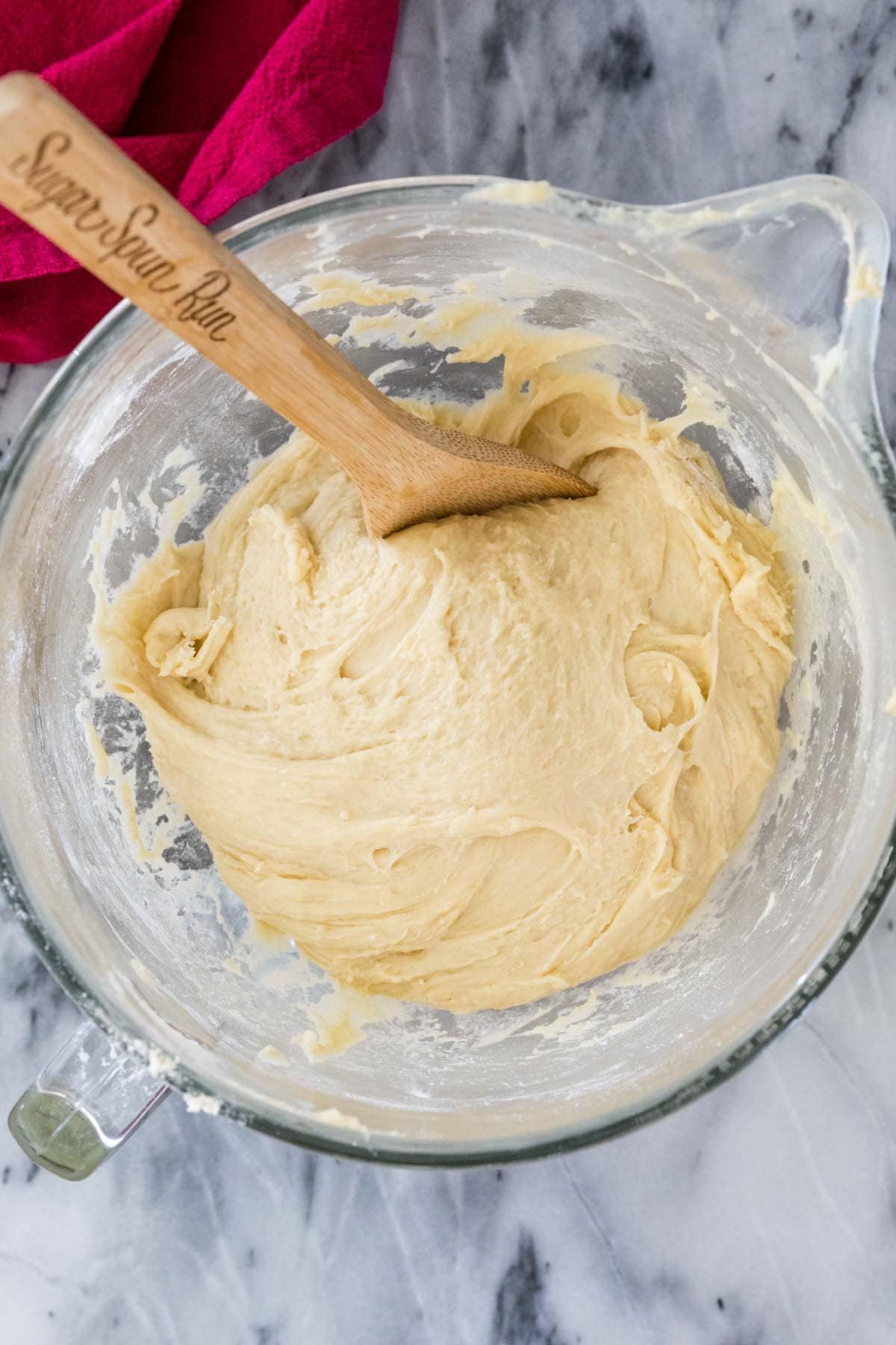 Overhead of tacky dough in mixing bowl before rising.