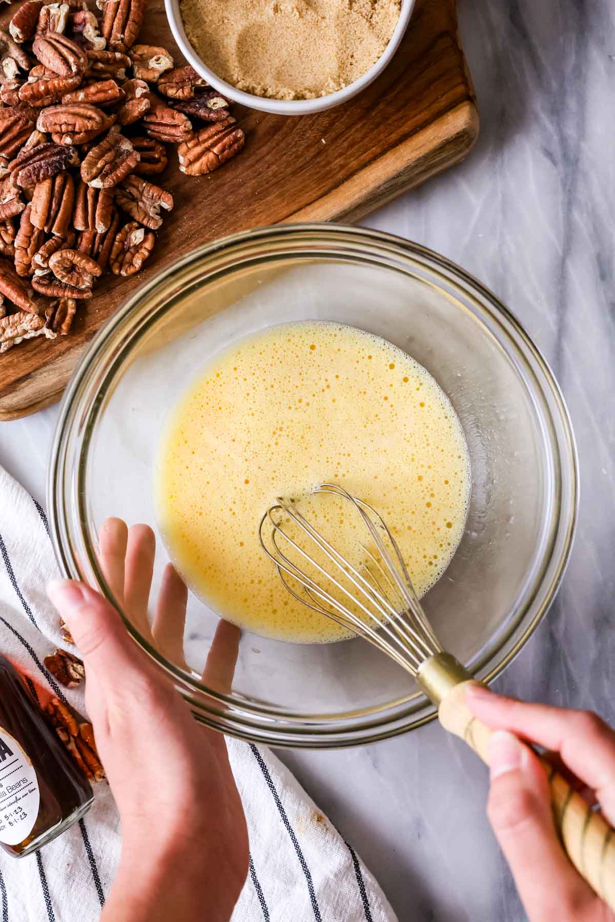 Overhead view of eggs being whisked until frothy.