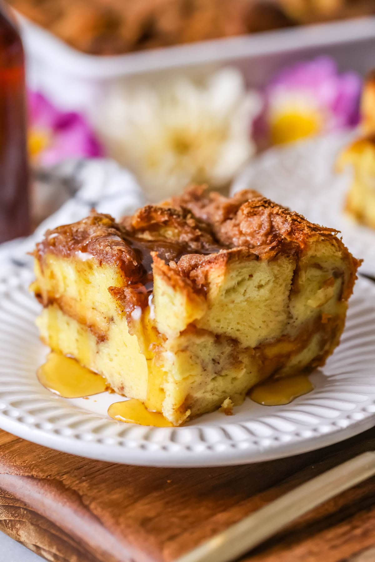 Square slice of casserole made with challah bread, custard, and streusel.