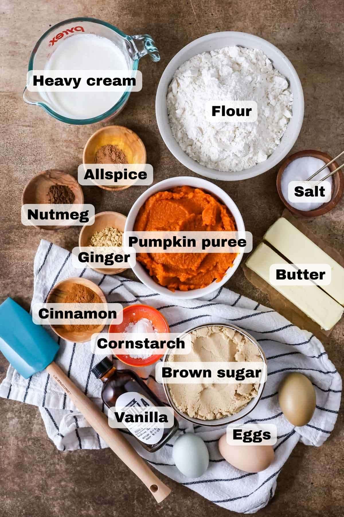 Overhead view of ingredients including pumpkin puree, brown sugar, cornstarch, eggs, and more.