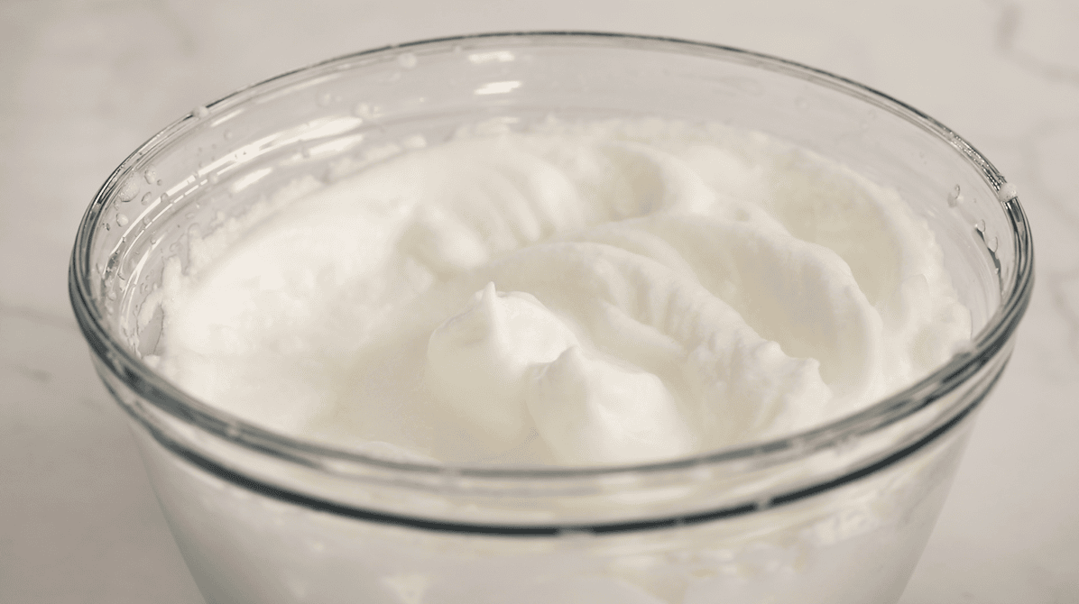 Bowl of egg whites that have been whipped to stiff peaks.