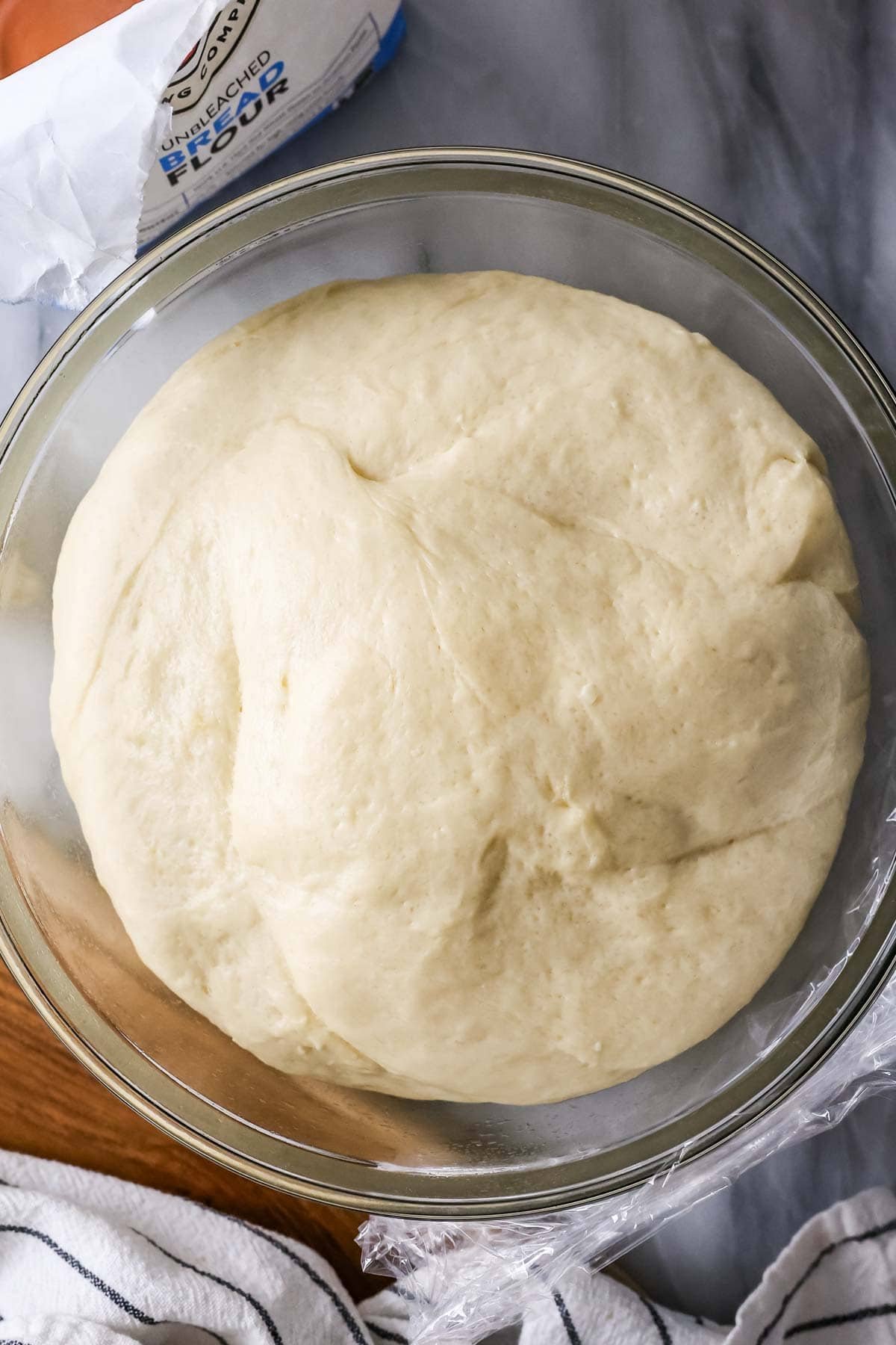 Overhead view of risen dough in a bowl.