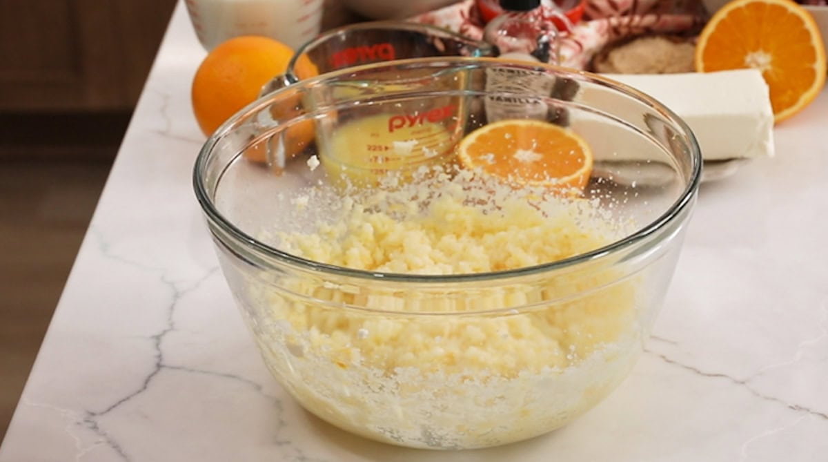 Creamed butter, sugar, oil, and orange zest in a bowl.