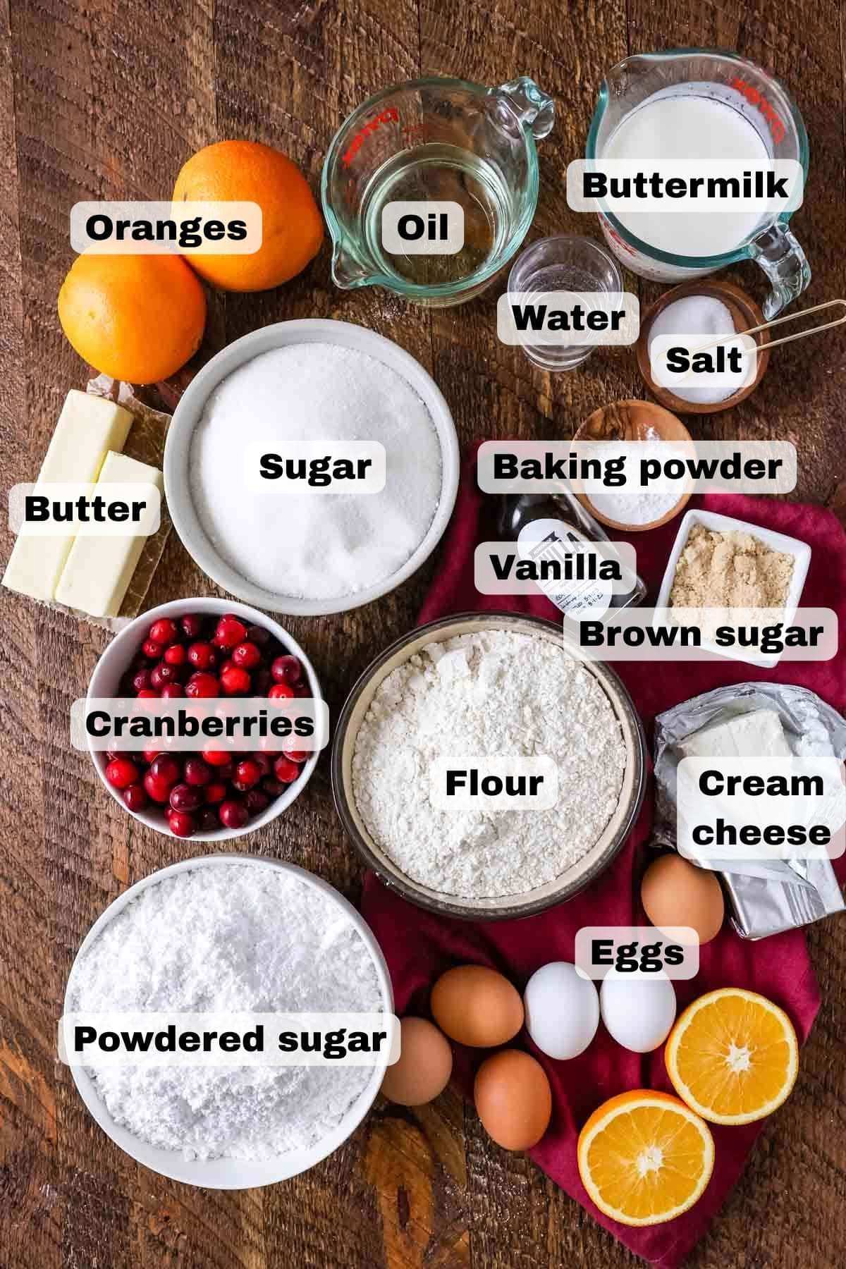 Overhead view of ingredients including oranges, cranberries, cream cheese, and more.