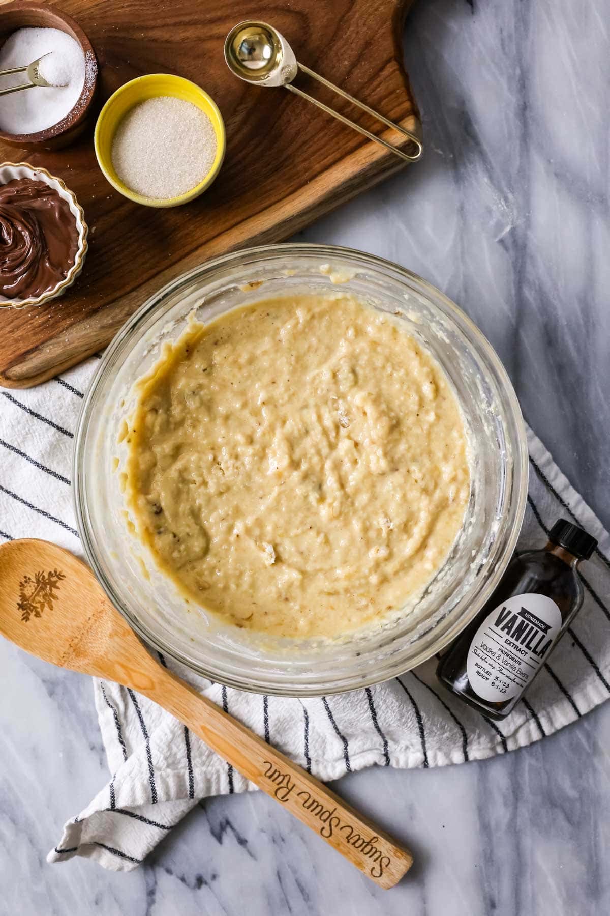 Overhead view of a banana batter in a bowl.