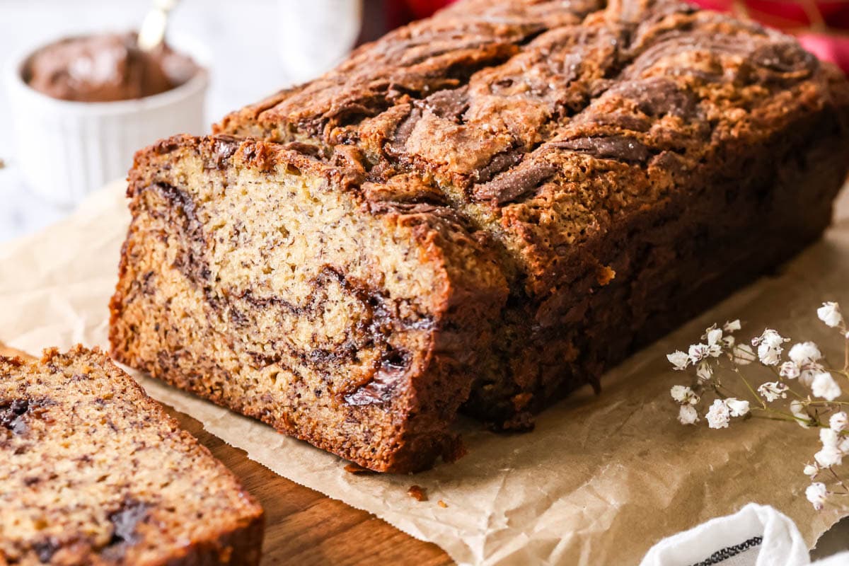 Loaf of banana bread with a swirl of Nutella in the middle and on top.