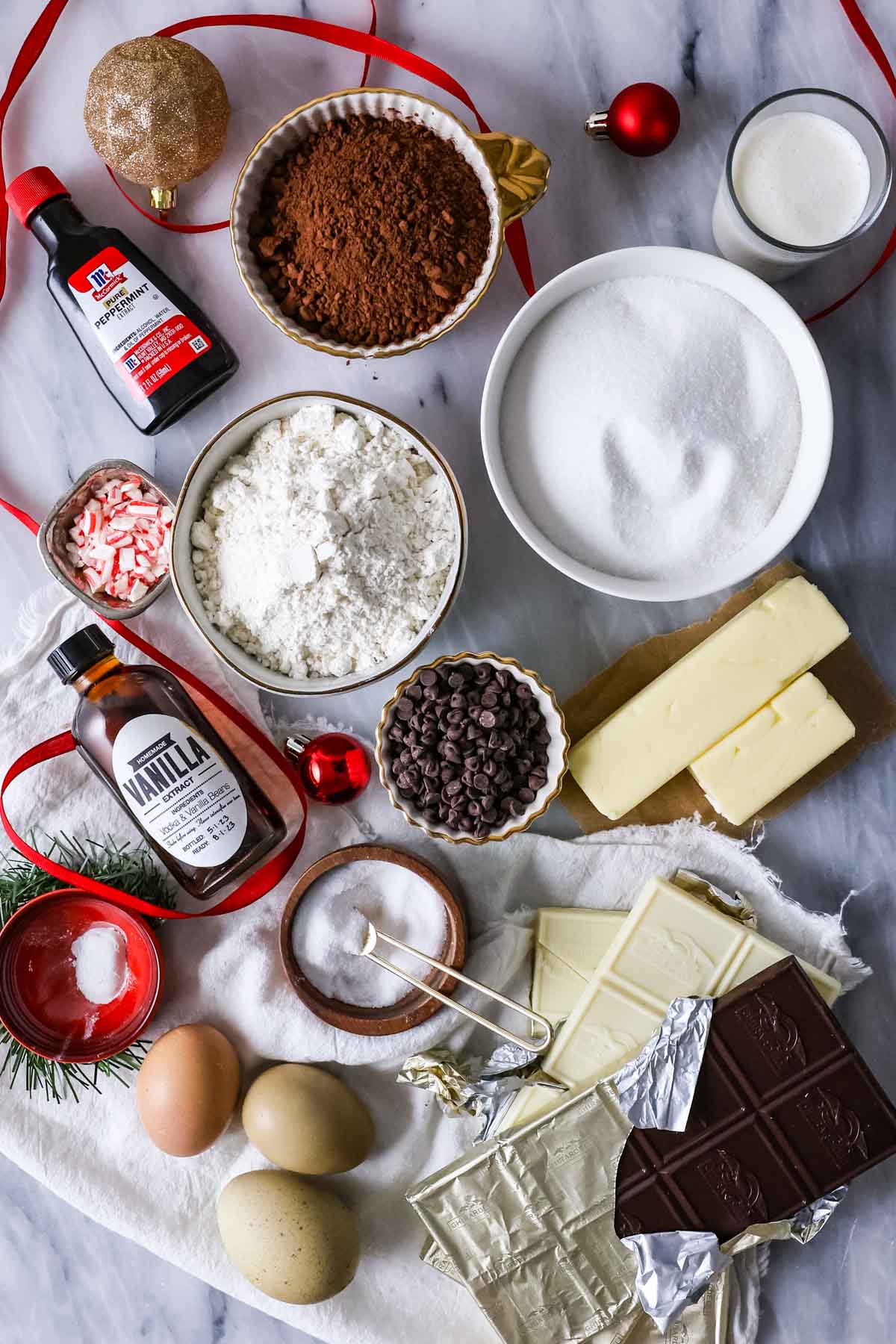 Overhead view of ingredients including cocoa powder, peppermint extract, white chocolate, and more.