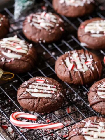 Close-up of chocolate peppermint thumbprint cookies on a cooling rack.