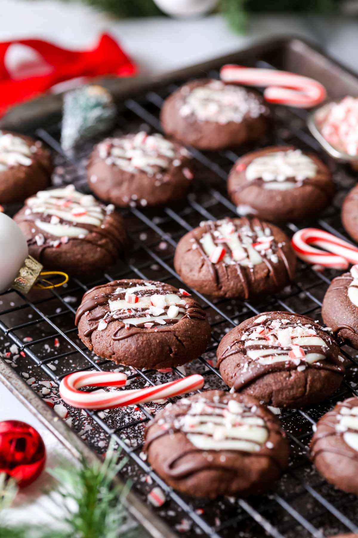 Close-up of chocolate peppermint thumbprint cookies on a cooling rack.