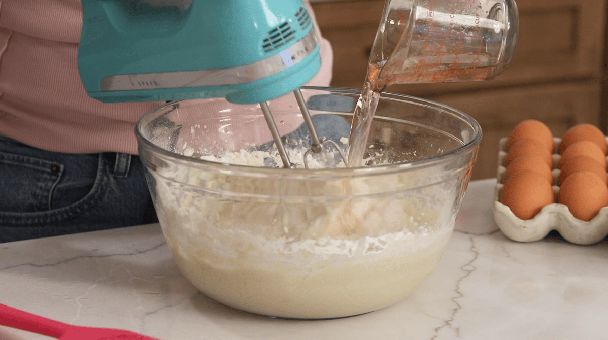 Mixing pink champagne into cake batter.