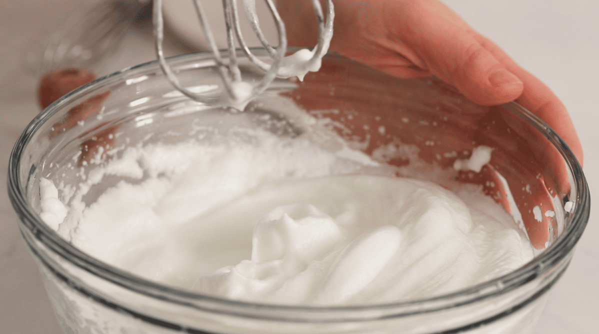 Close-up of egg whites whipped to stiff peaks.