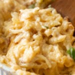 Close-up view of a spoonful of loaded hash brown casserole made from-scratch.