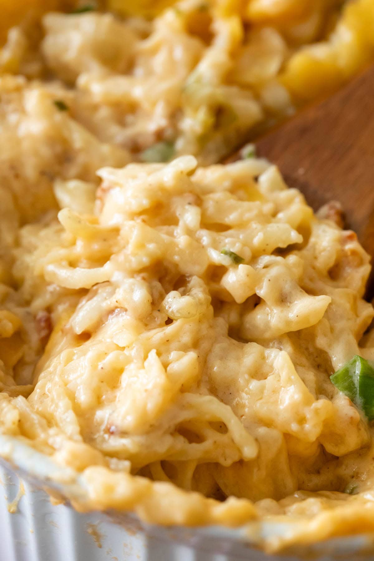 Close-up view of a spoonful of loaded hash brown casserole made from-scratch.