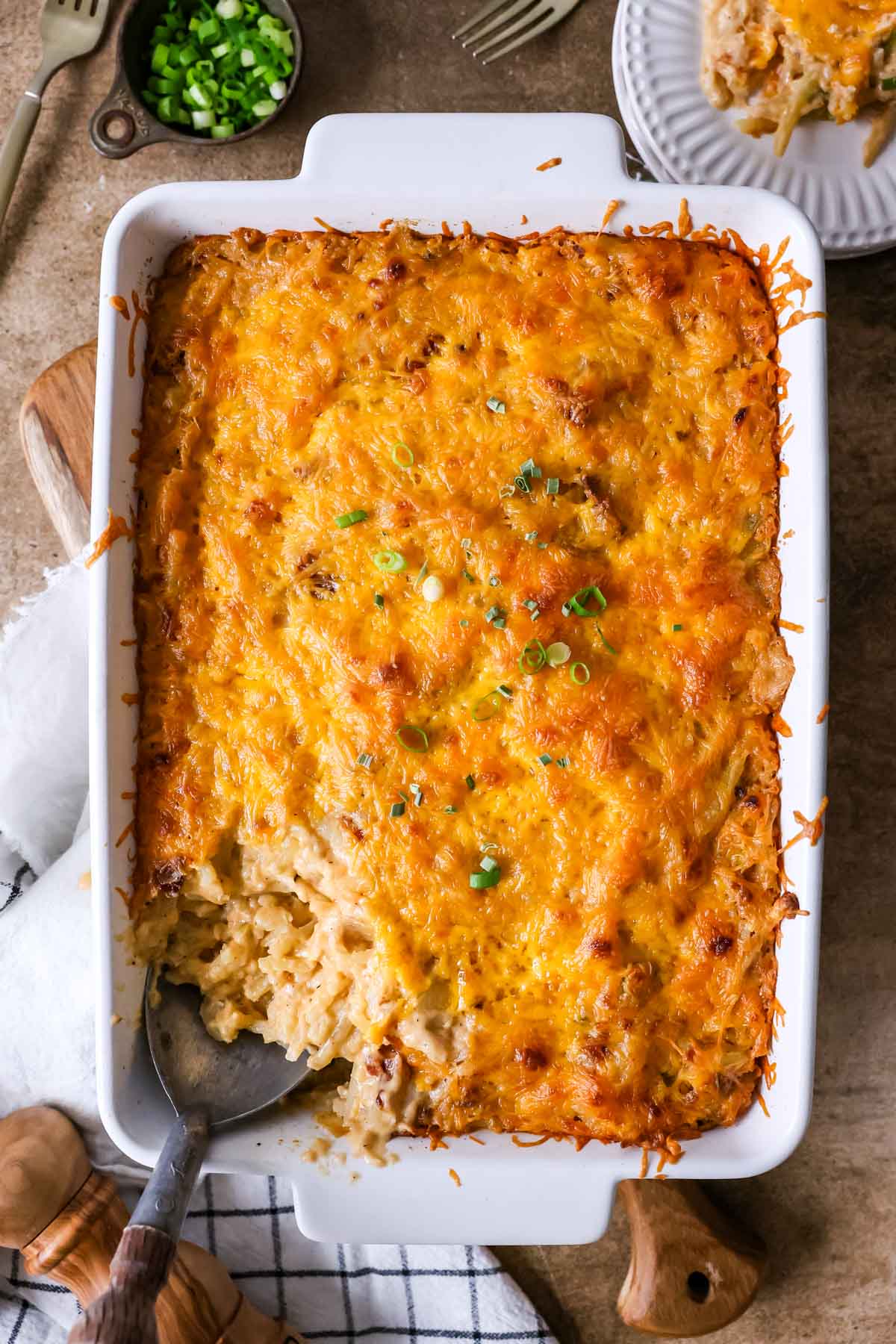 Overhead view of a pan of casserole made with hash browns, cheese, bacon, and more.