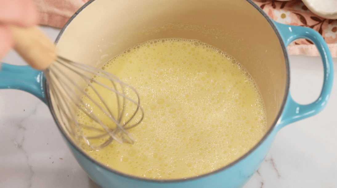 Overhead view of pastry cream in a pot before thickening.