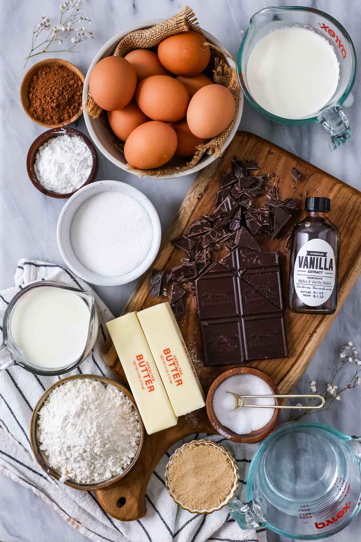 Overhead view of ingredients including chocolate, eggs, milk, and more.