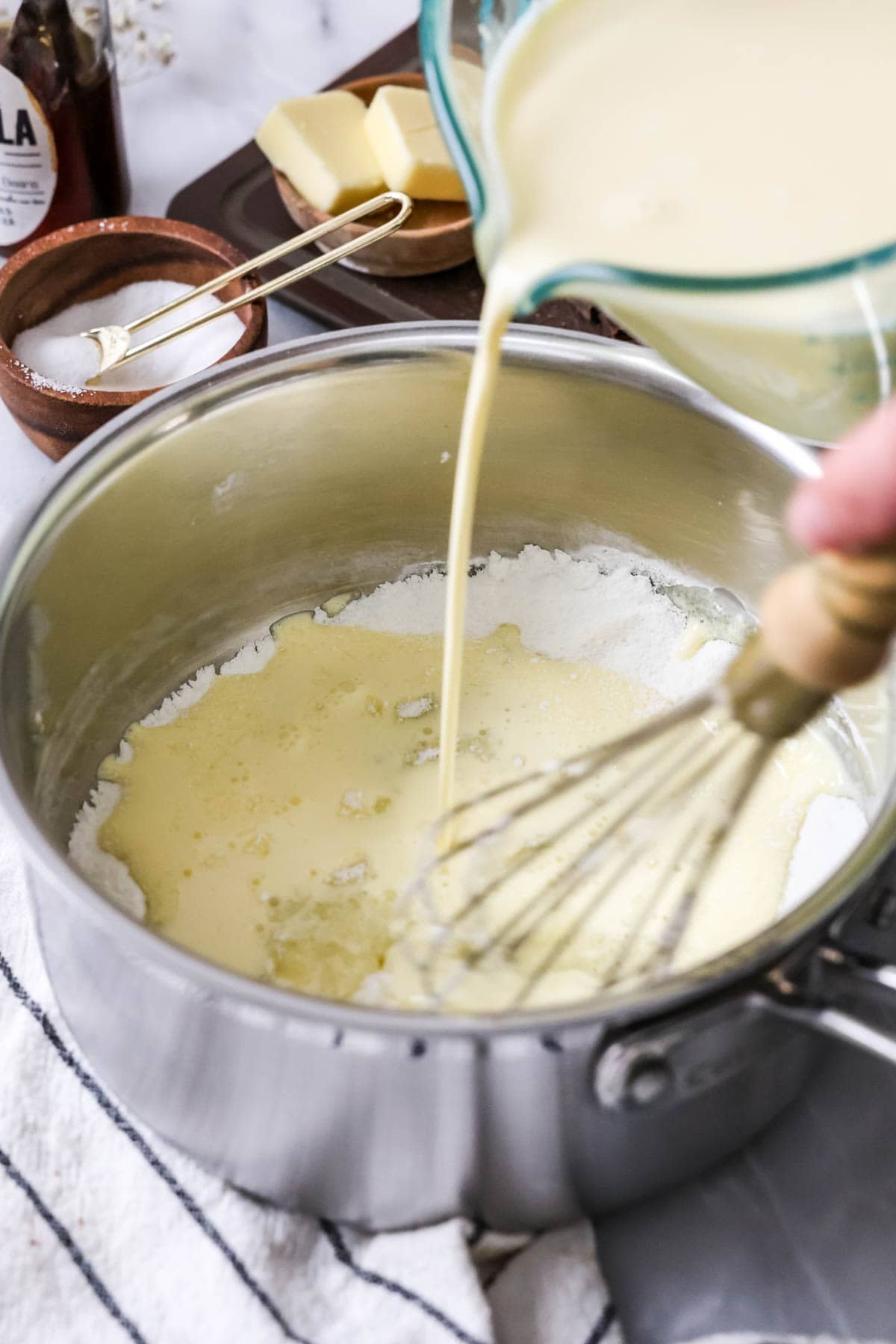 Overhead view of a custard mixture being poured into a cornstarch and sugar mixture.
