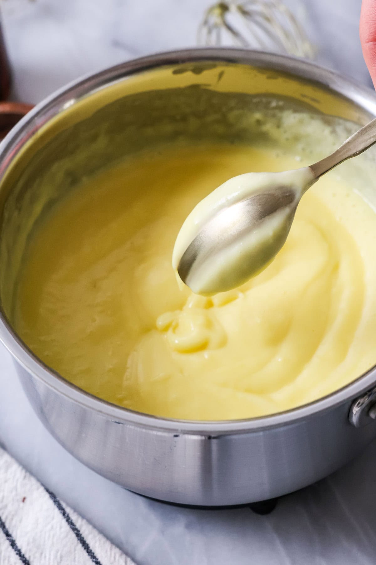 Spoon that's been dipped in custard and swiped to show the custard has thickened properly.