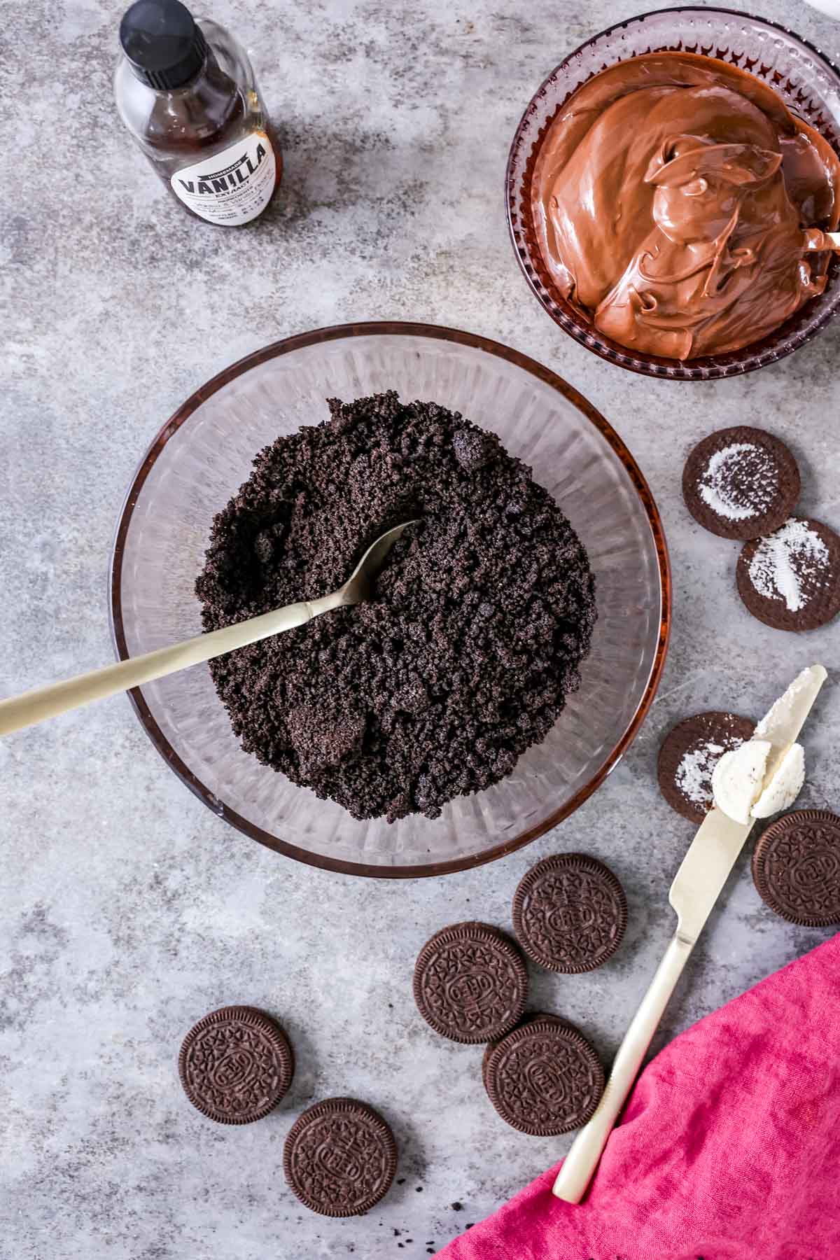 Overhead view of Oreo crumbs and butter mixed together in a bowl.