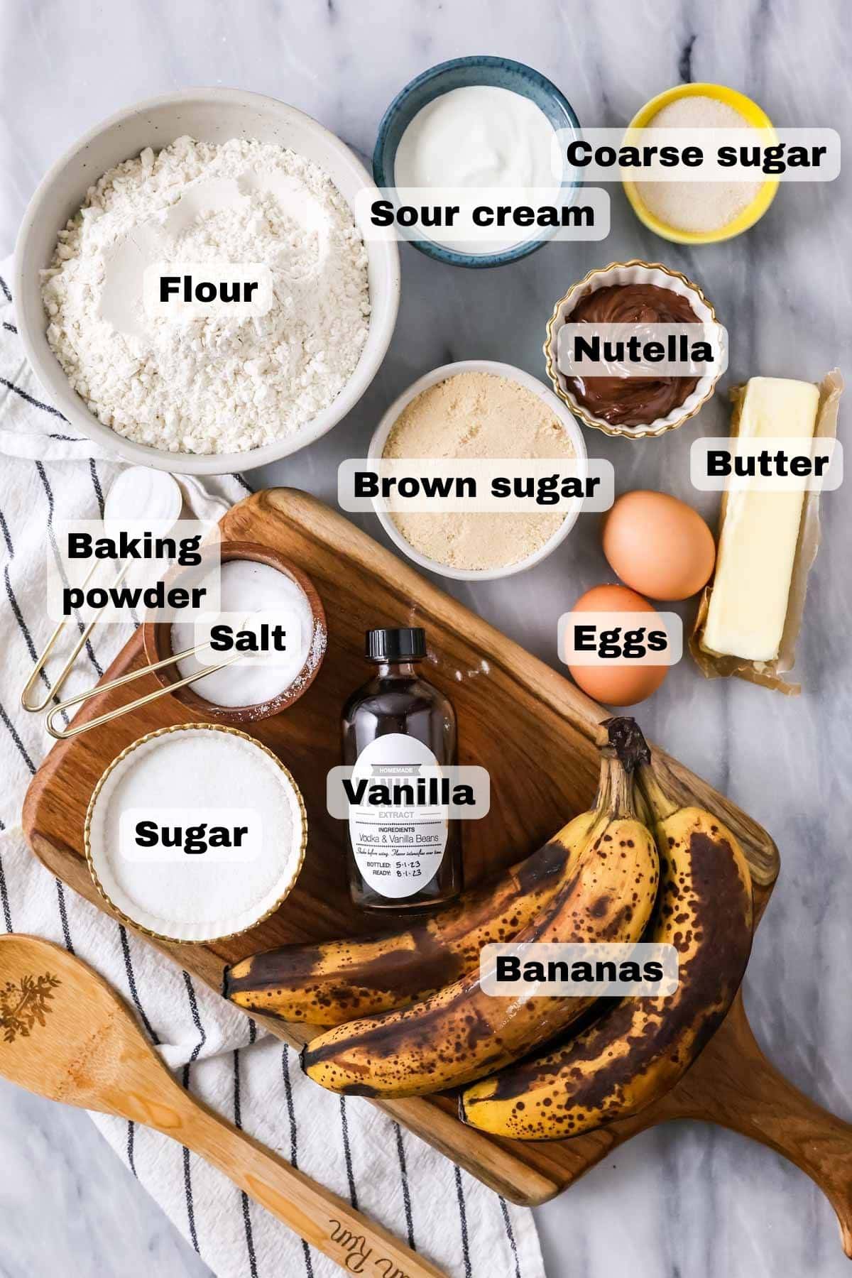 Overhead view of ingredients including bananas, nutella, eggs, and more.