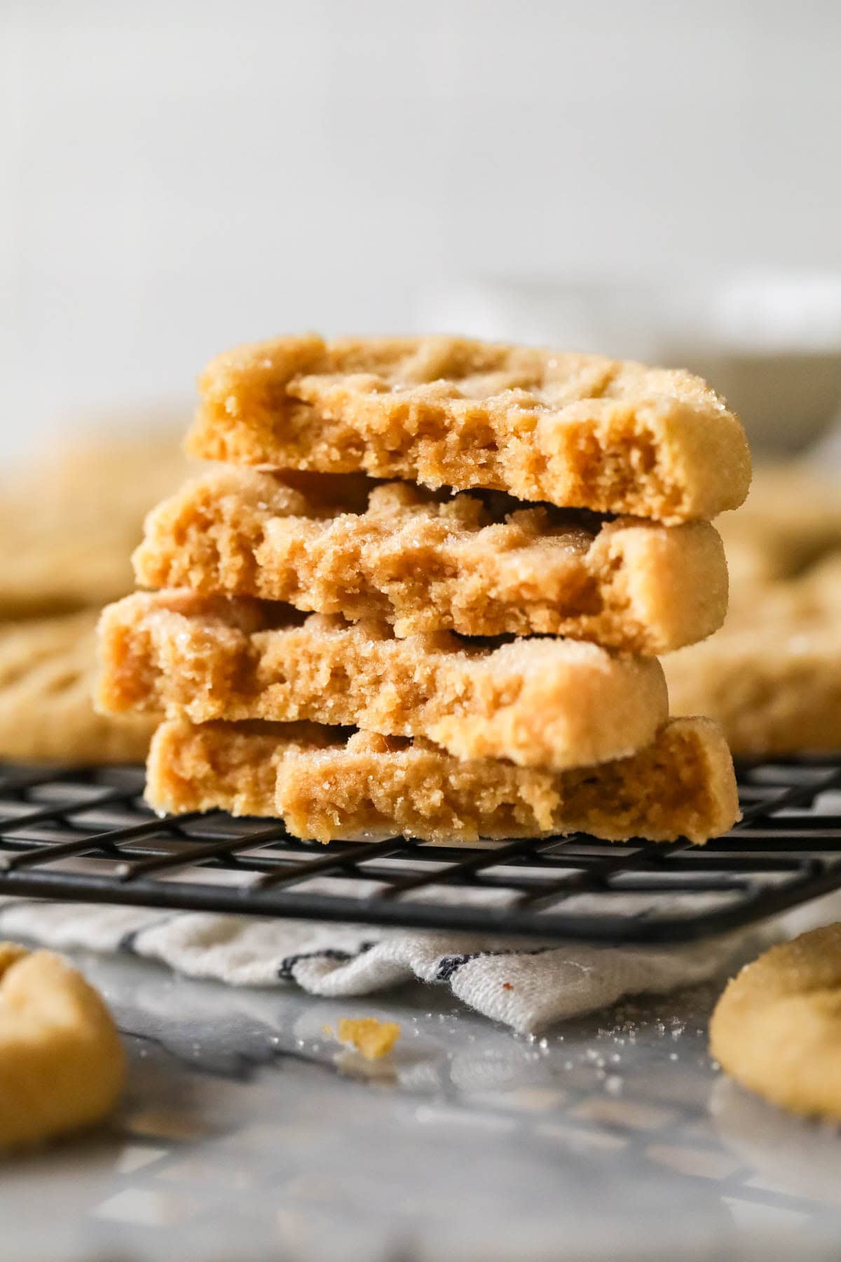 Stack of cookie halves on a cooling rack.