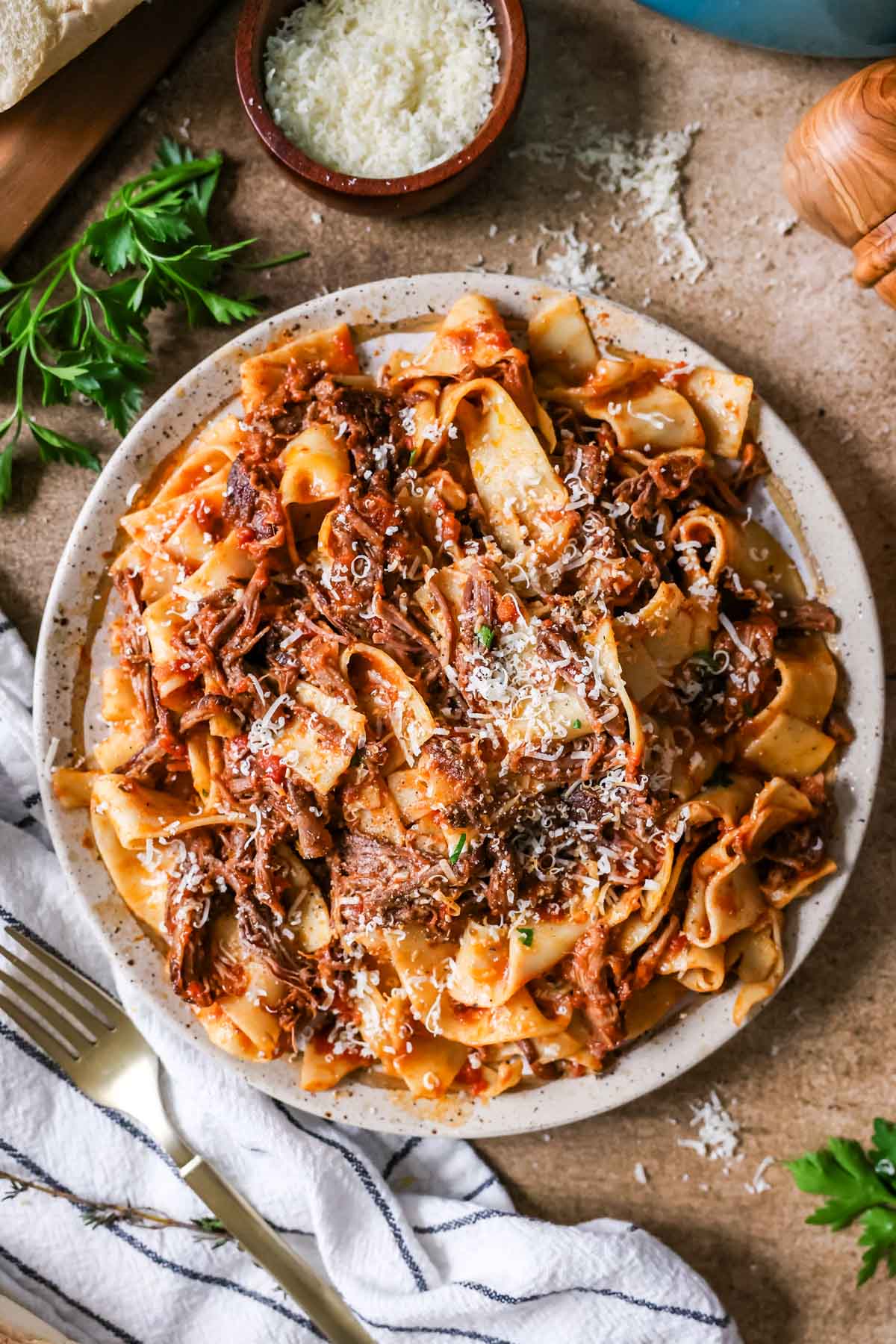 Overhead view of short rib ragu tossed with pappardelle pasta.