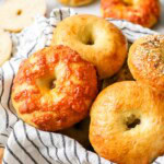 Close-up view of sourdough bagels of vary flavors, including plain, cheese, and everything.