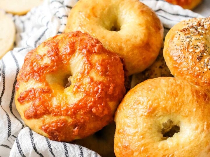 Close-up view of sourdough bagels of vary flavors, including plain, cheese, and everything.