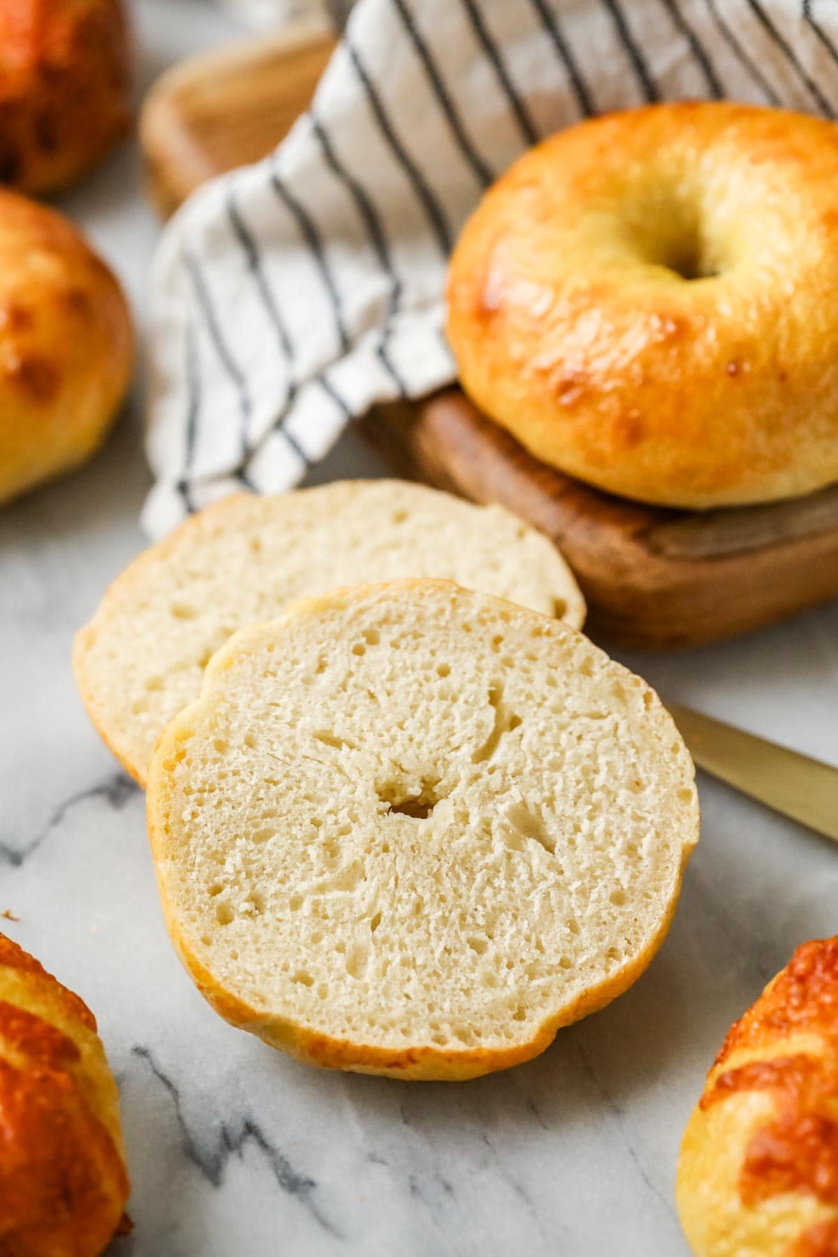 Sourdough bagel that has been cut in half to show it's interior texture.