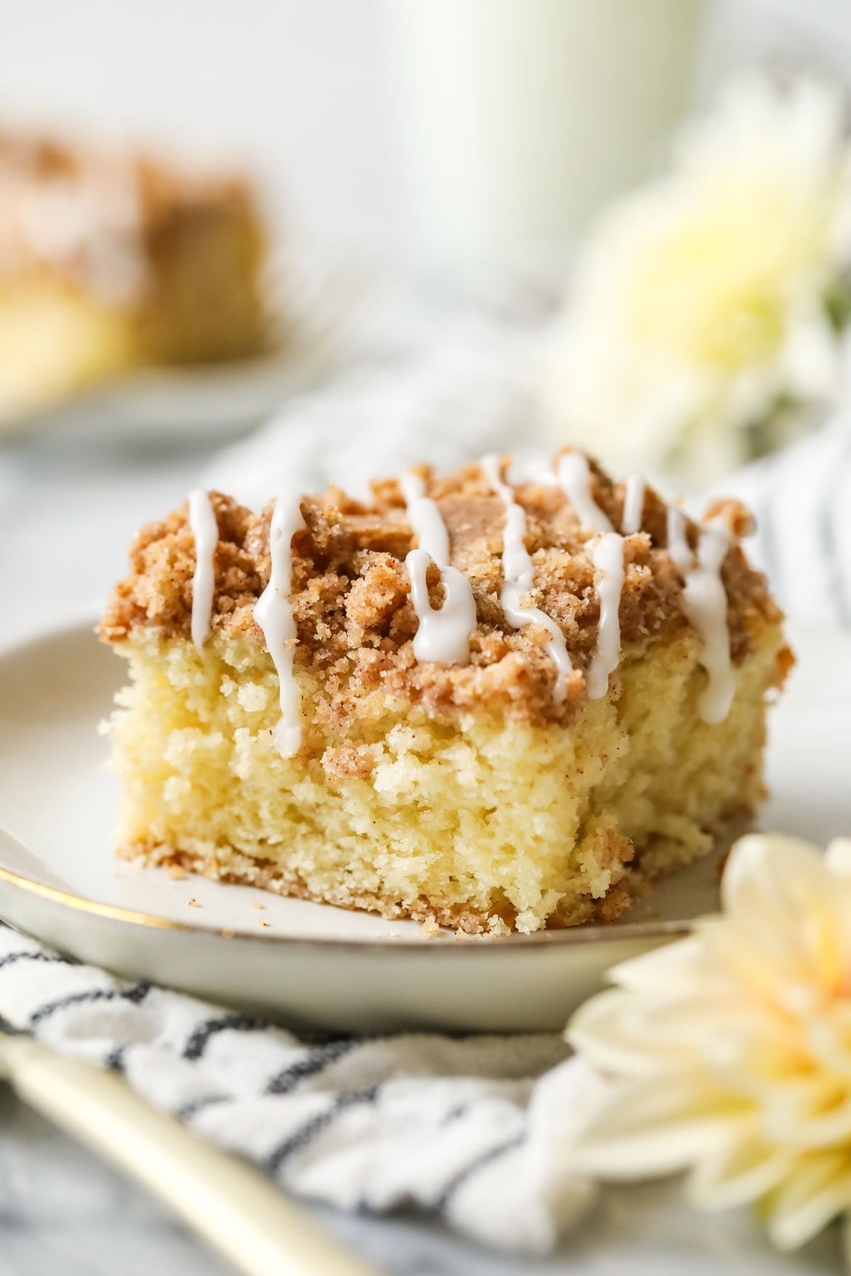 Slice of sourdough coffee cake made with sourdough discard on a white plate.