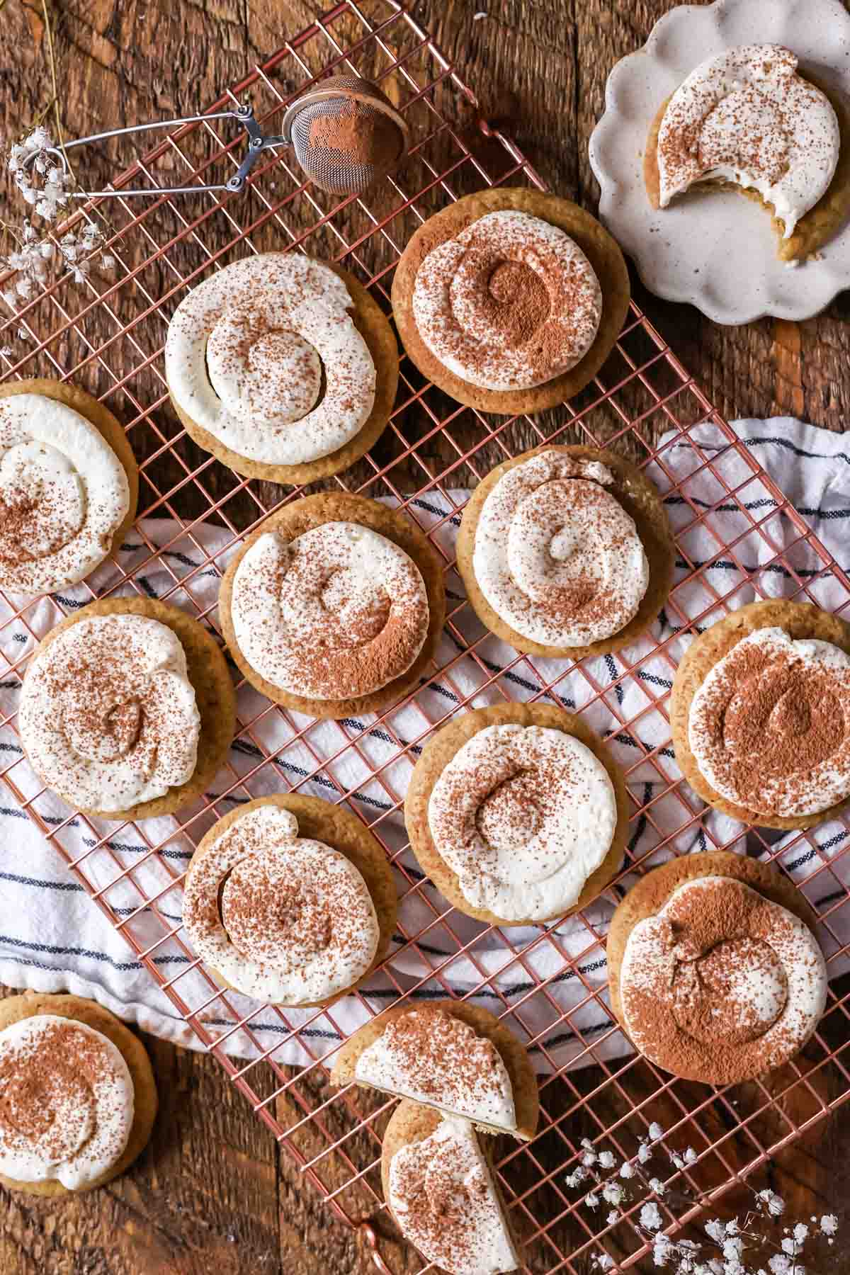Overhead view of espresso soaked cookies with a mascarpone frosting and cocoa powder on a cooling rack.