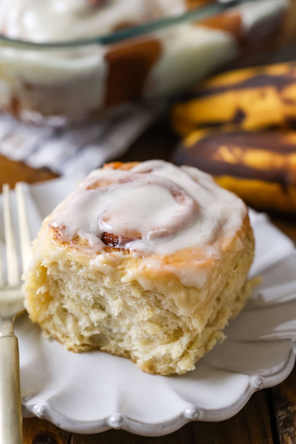 Iced cinnamon roll on a plate.