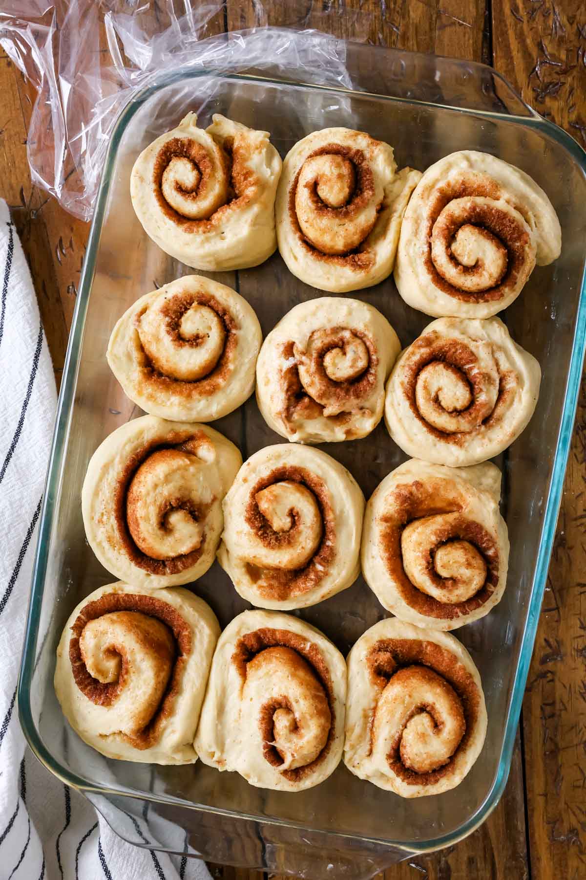 Overhead view of banana cinnamon rolls in a pan after rising.