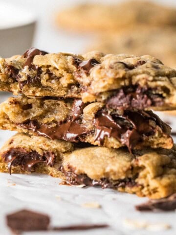 Several halves of choc-oat-chip cookies stacked on top of each other.